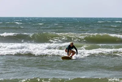 Surfing in Mui Ne: a student holding the line on the whitewater