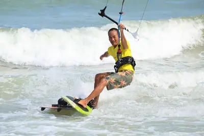 A K1 rider carving through the whitewater on Sandunes beach
