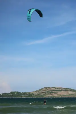 A kite above the sea and the Mui Ne hills