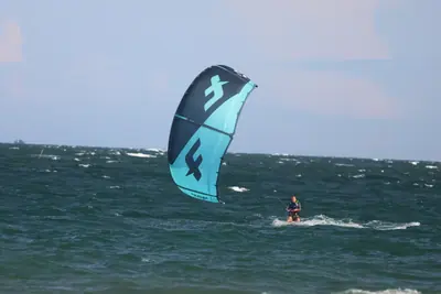 An F-One kite and its rider on the water, Mui Ne