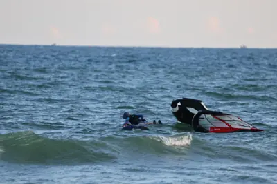 Students paddling their foil boards with the wings on the water